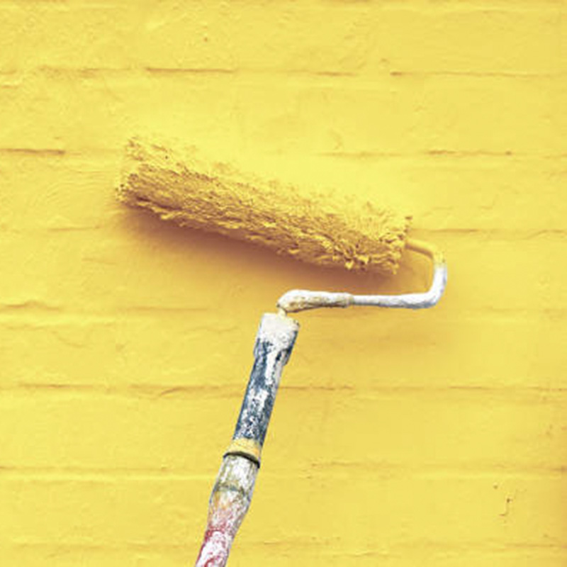 Imagen de rodillo y pintura amarilla